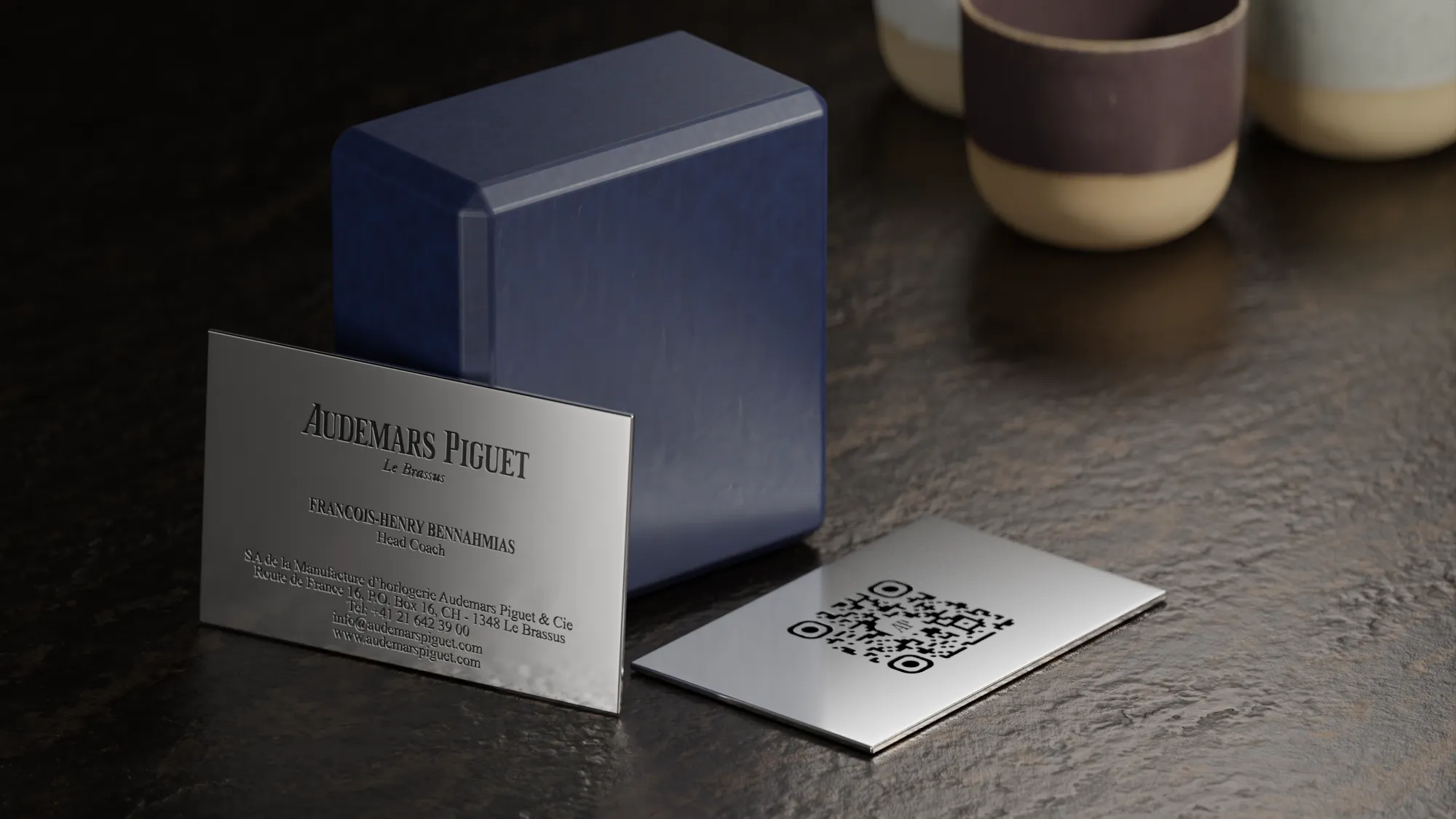 rendered Audemars Piguet business cards on bronze table scene